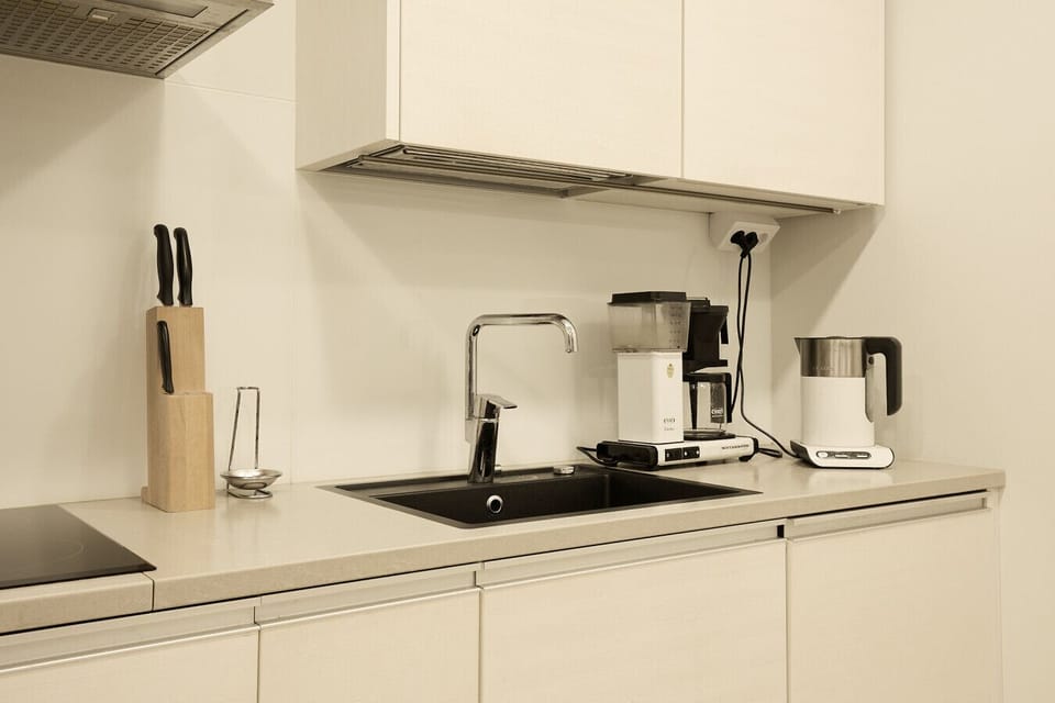 Modern and bright kitchen workspace featuring a quality coffee maker, kettle, and sleek minimalist design.