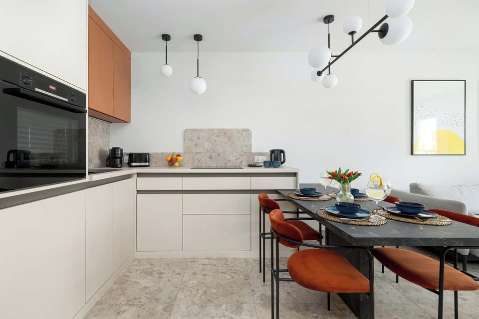 Stylish dining space with a modern table setting and open kitchen background.