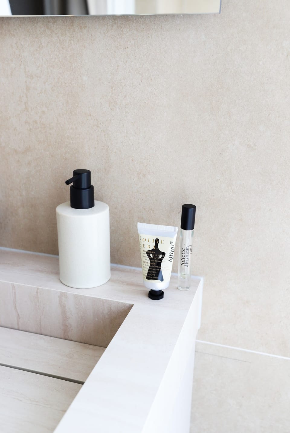 Clean, calming and complete — elegant bathroom amenities on a warm-toned stone basin.