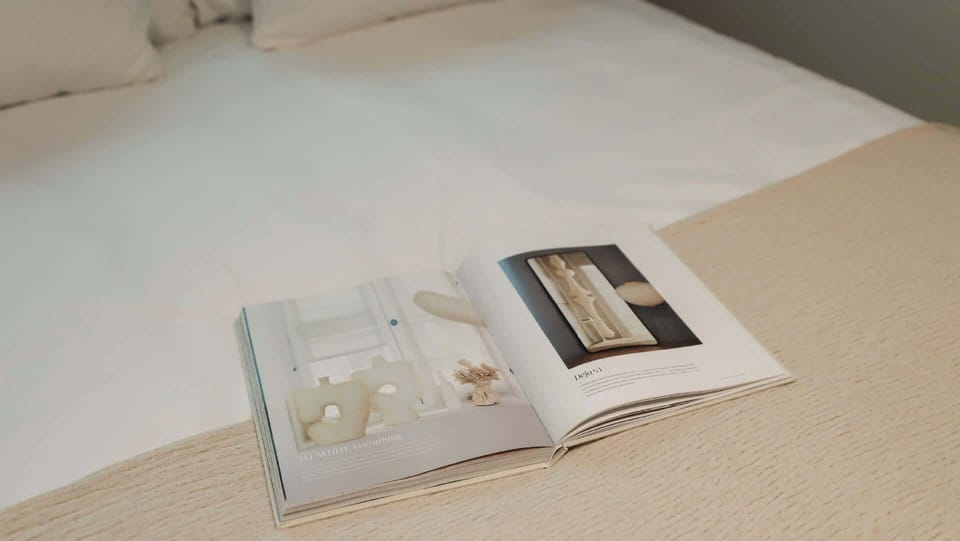 A moment of calm — soft bedding, reading material and a neutral palette to help you slow down.