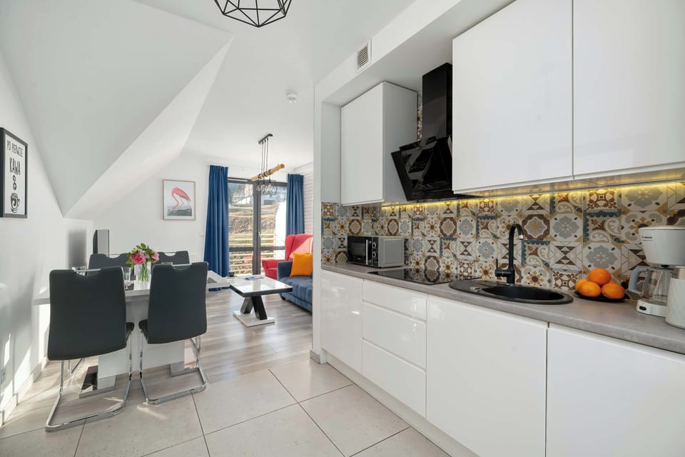 The sleek design of the kitchenette blending seamlessly with the living area.