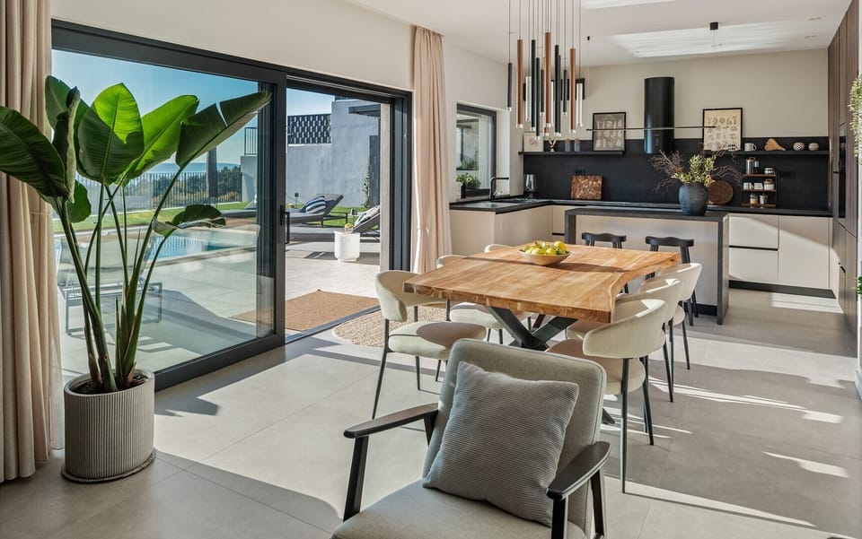 The turquoise 32 sqm pool and green lawn, securely fenced and overlooking the impressive mountains.