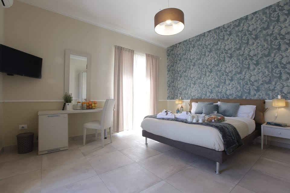 Deluxe Quadruple Room, Garden View | Down comforters, free WiFi