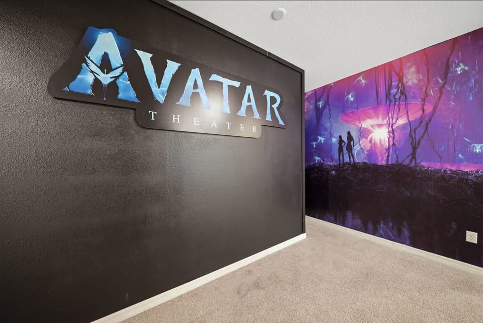 Experience a unique entertainment space adorned with a stunning "Avatar" mural that adds vibrant colors and adventure to your stay. Enjoy the plush carpet underfoot, perfect for cozy movie nights or relaxing with friends.