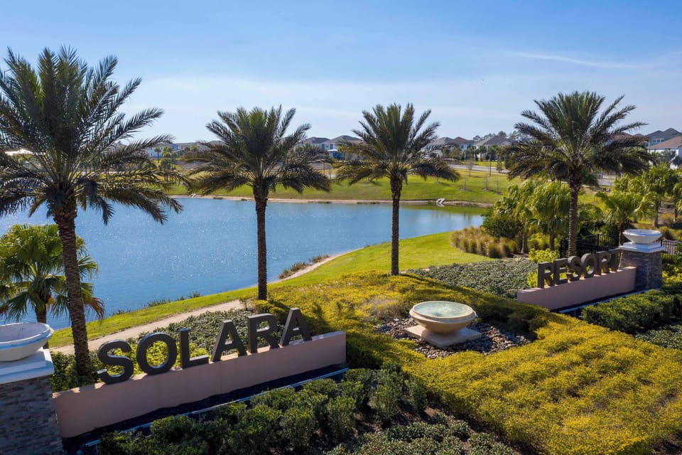 Enjoy stunning water views from this beautifully landscaped property, where lush greenery and palm trees create a serene atmosphere. Relax in the cozy outdoor seating area, perfect for soaking up the sun and fresh air.