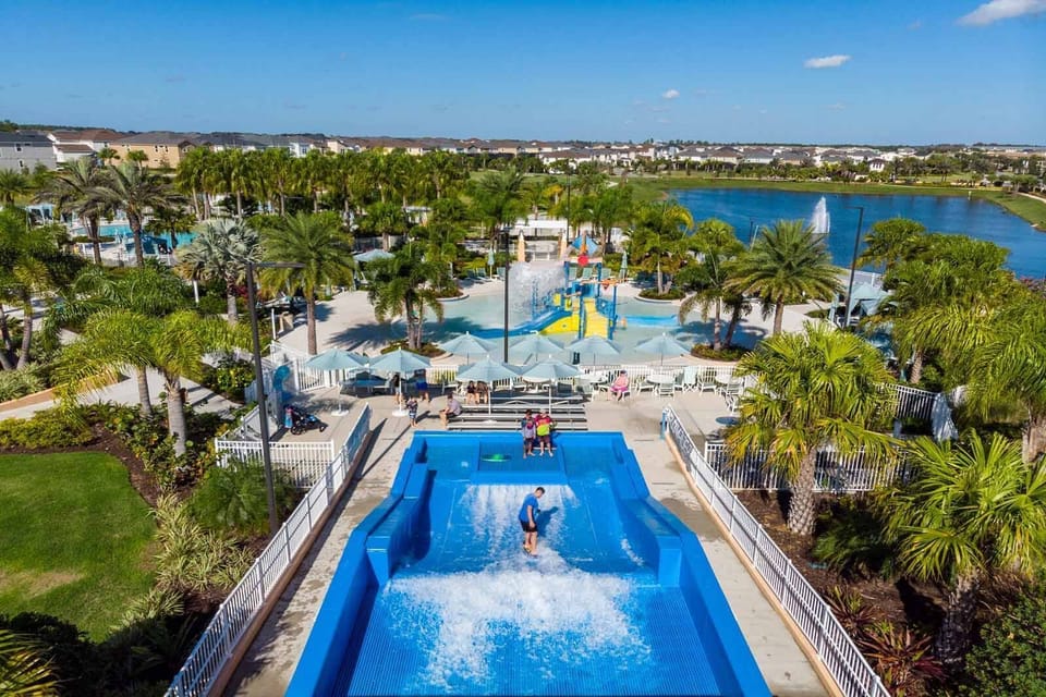 Experience the thrill of a vibrant water park directly from your balcony, where colorful slides and sparkling pools invite fun-filled days. Lush palm trees frame this sunny paradise, ensuring a picturesque view at every moment.