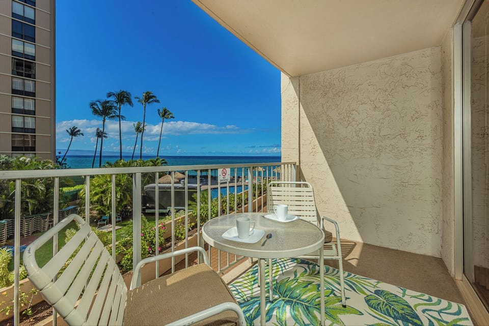 Your private balcony overlooks swaying palms, tropical gardens, and sparkling ocean waters.