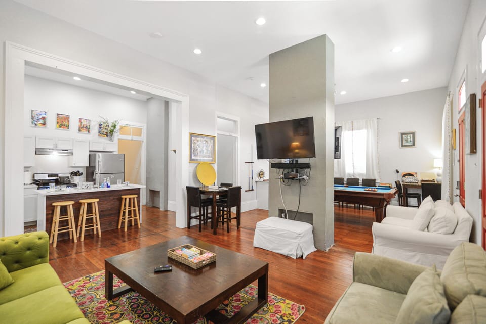 Living Room- tons of seating, wall mounted TV, streaming services, natural light