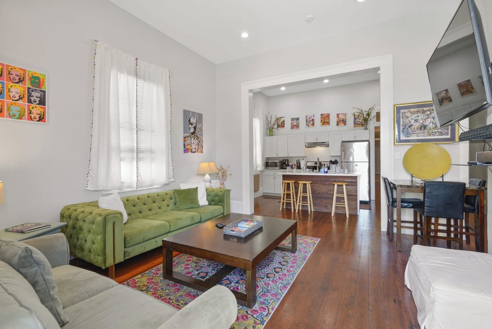 Living Room- tons of seating, wall mounted TV, streaming services, natural light