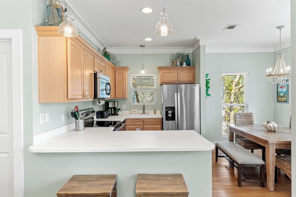 Your fully equipped kitchen features stainless steel appliances, spacious counters, and a breakfast bar perfect for morning coffee or casual meals.