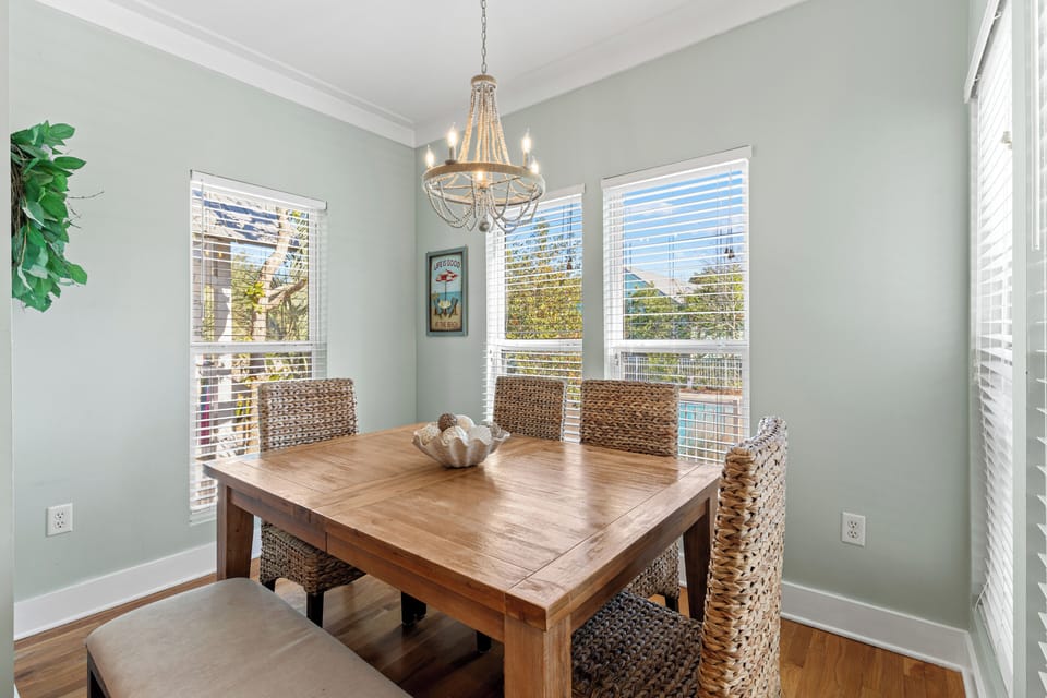 Gather around your elegant dining table for memorable meals, surrounded by natural light streaming through large windows.
