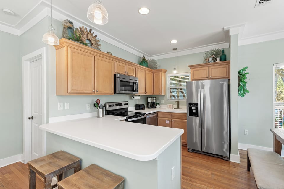 Your fully equipped kitchen features stainless steel appliances, granite countertops, and warm wood cabinetry for comfortable meal preparation.