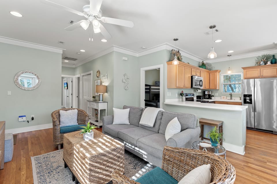 Relax in your bright open-concept living space with cozy seating, modern kitchen, and coastal touches throughout.