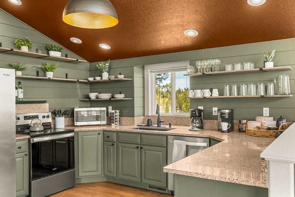 Fully stocked luxury kitchen with modern mountain décor, premium finishes, a curated coffee bar, and everything needed for memorable family meals and group gatherings.