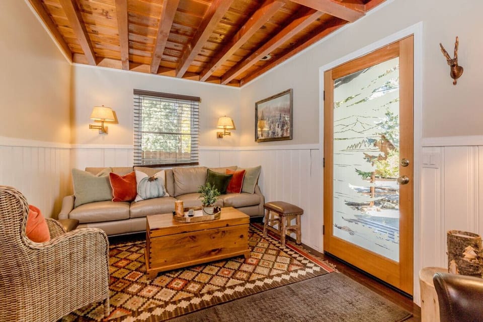 Cozy cabin style living room with rustic details and comfortable furnishings.