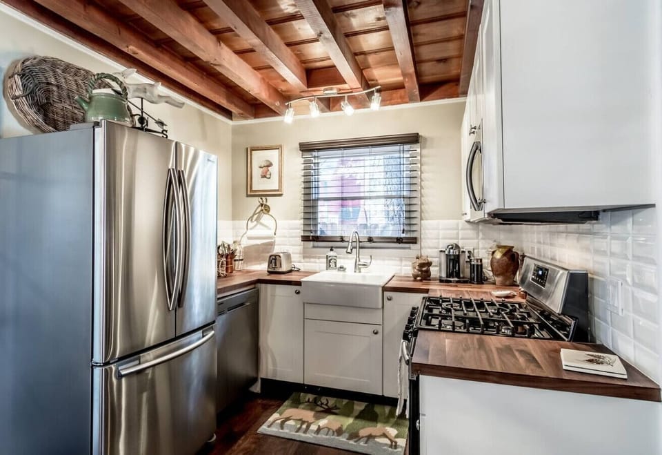 Modern rustic kitchen with stainless appliances and farmhouse sink