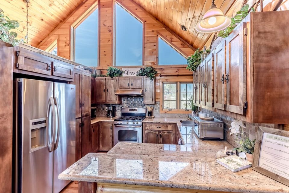Fully equipped kitchen with granite counters, stainless appliances, and plenty of space for group meals
