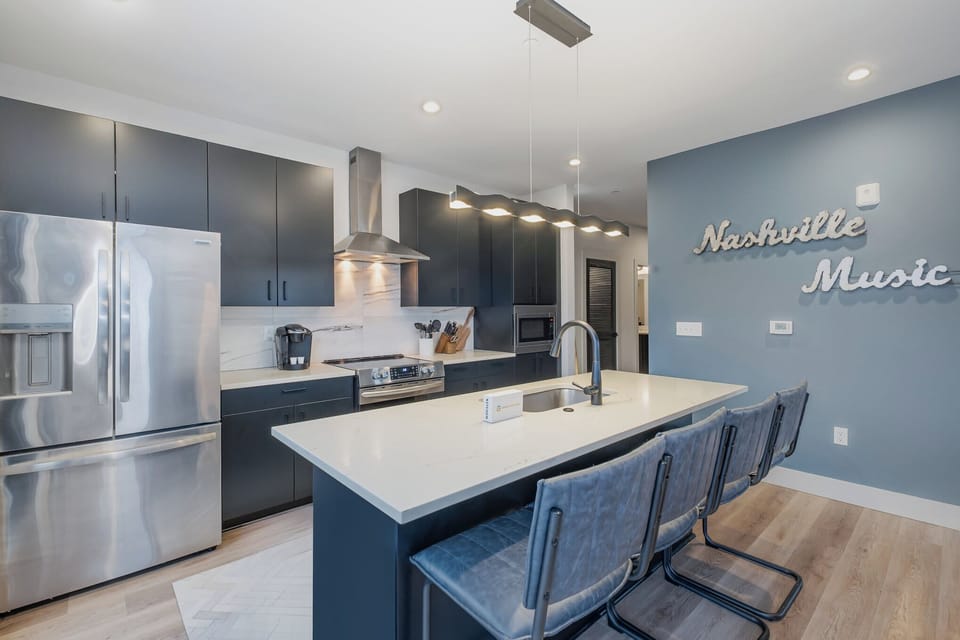 Sleek, modern kitchen with large island for dining and easy access to the living area.