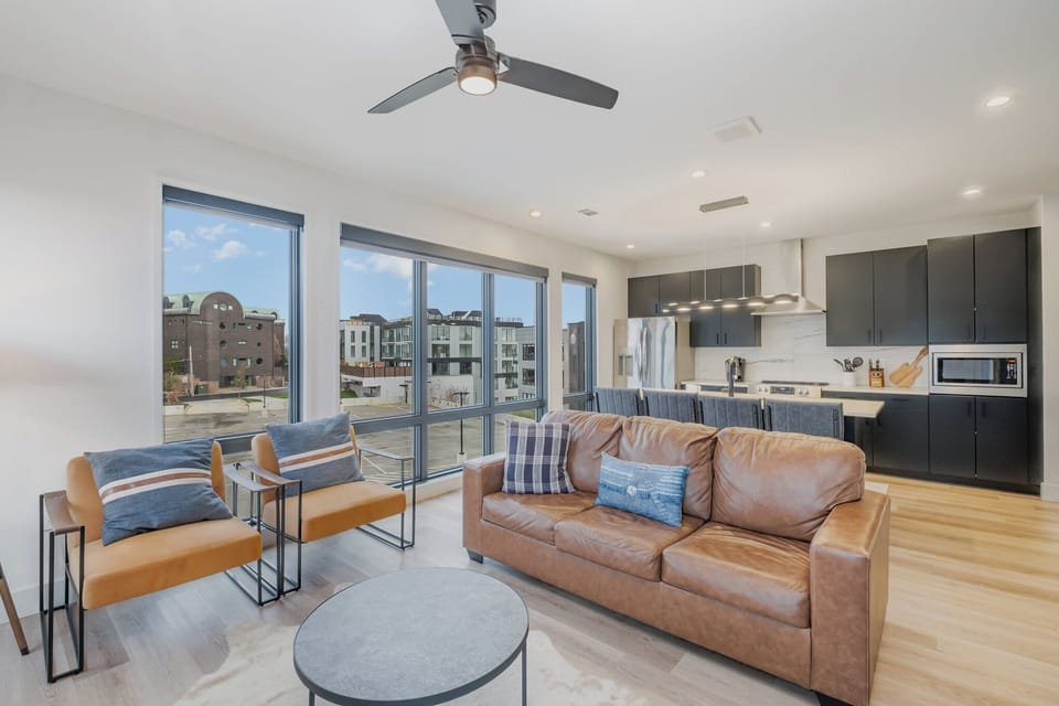 Modern open concept living. Leather sofa, Smart TV, and kitchen island seating for 4.