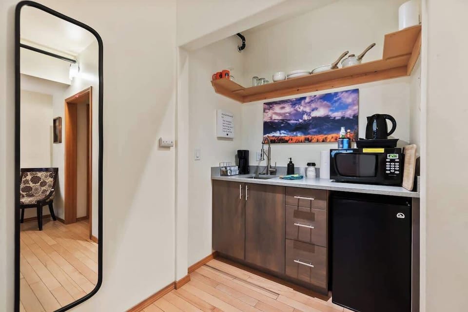 Kitchenette with coffee bar, sink, microwave, and mini fridge