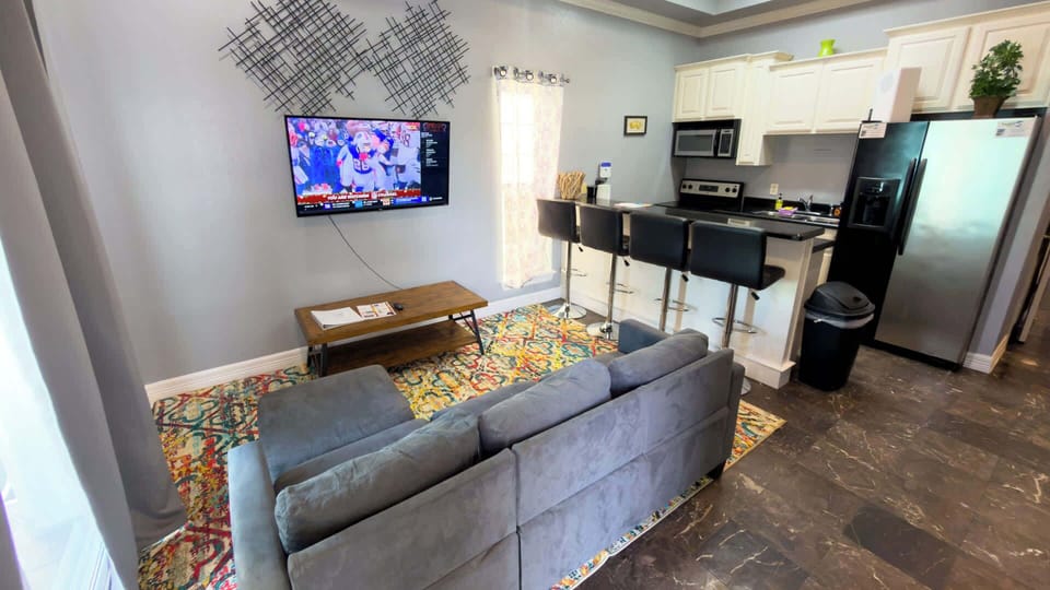 A bright, easygoing living space where soft light, simple décor, and an open layout create a naturally welcoming flow. A comfortable spot to unwind, share moments, and settle into a stay that feels calm, connected, and effortlessly livable.