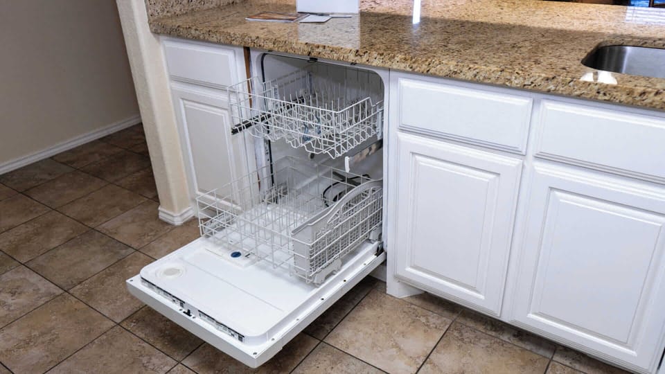 Spotless Kitchen Dishwasher
Full-size dishwasher under granite counters loads effortlessly next to the sink. White cabinets and tiled floors make cleanup quick after beach picnics—enjoy sparkling dishes and more time relaxing seaside.
