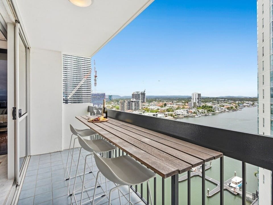 Private riverfront balcony with seating, river outlook and city skyline outlook.