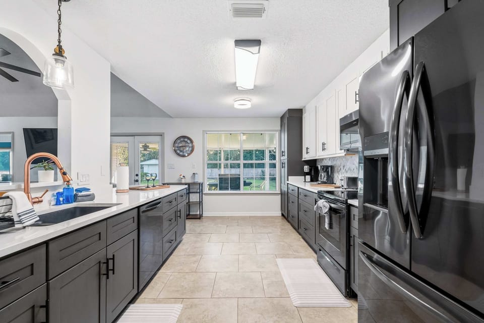 Modern kitchen w/ stainless appliances, sleek counters & plenty of prep space