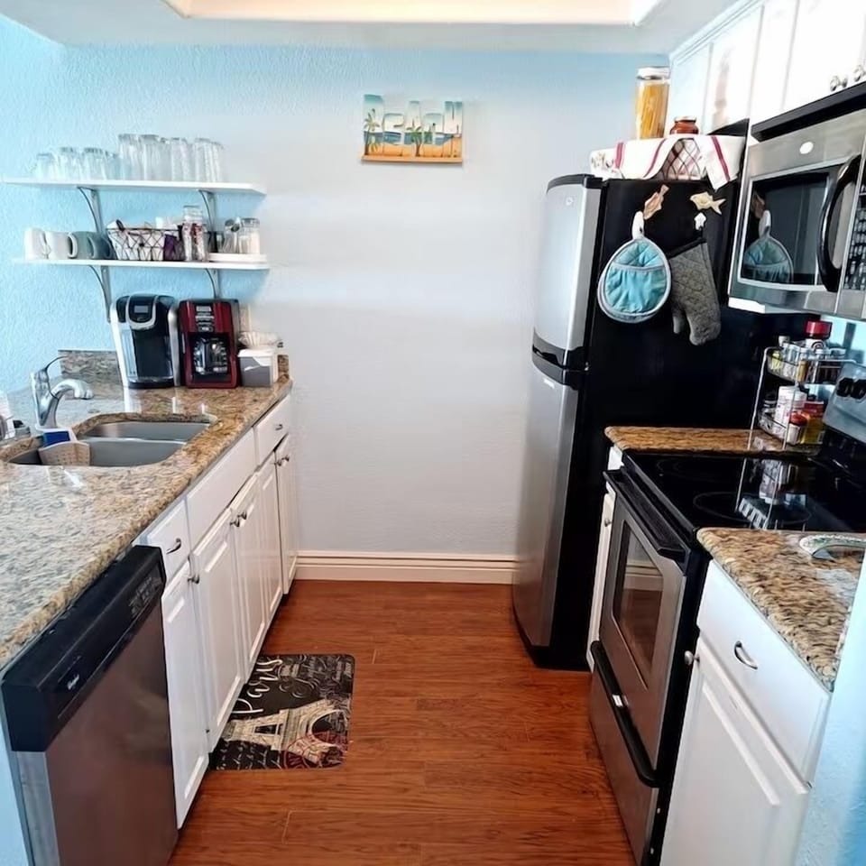 Kitchen has dishwasher, disposal, microwave, range in refrigerator with icemaker