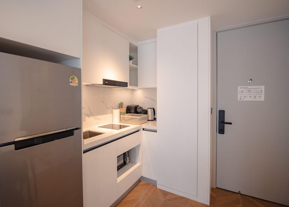Fully equipped modern kitchen with built-in appliances and sleek finishes.
