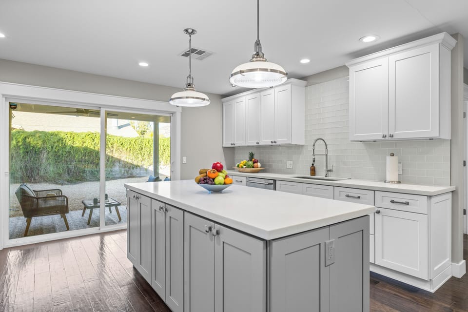 Kitchen view showing the island and access to the outdoor patio.