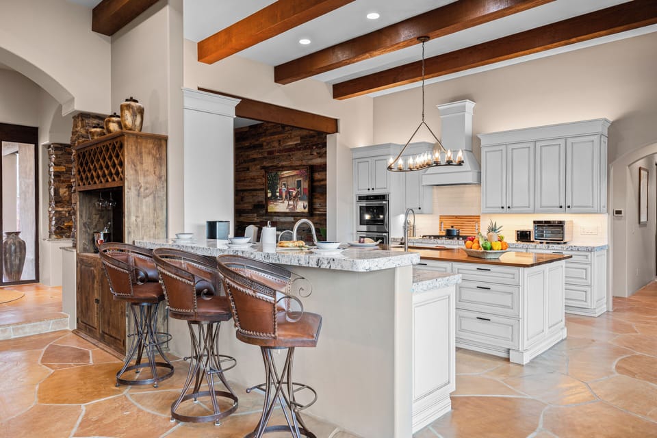Bright and luxurious kitchen with high-end appliances and inviting bar seating.
