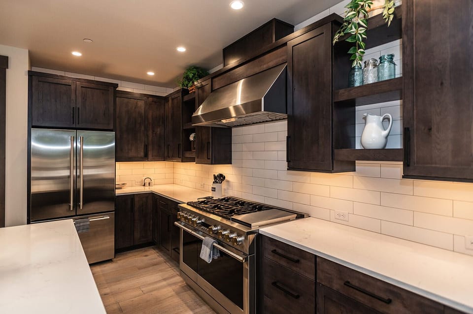 A chef’s kitchen where stainless steel meets warm wood and serious cooking happens.
