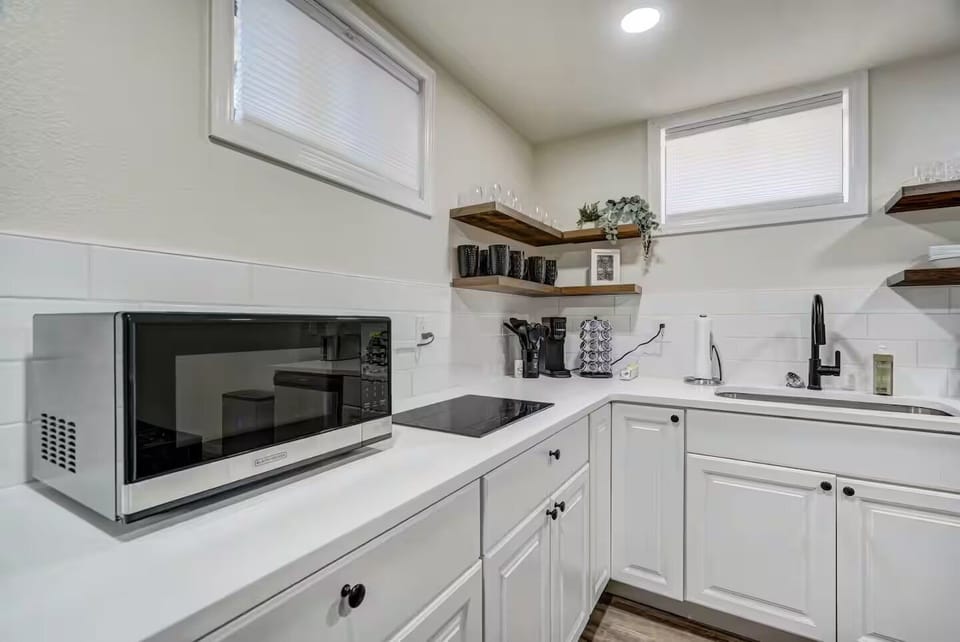 Prepare delicious meals in the fully stocked kitchen, equipped with a cooktop, microwave, dishwasher, and all the cooking utensils you might need.