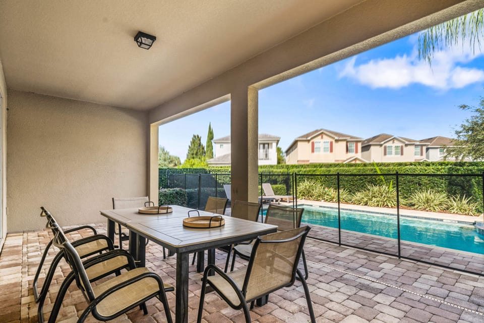 Enjoy shaded outdoor dining on the covered patio with views of the pool just steps away