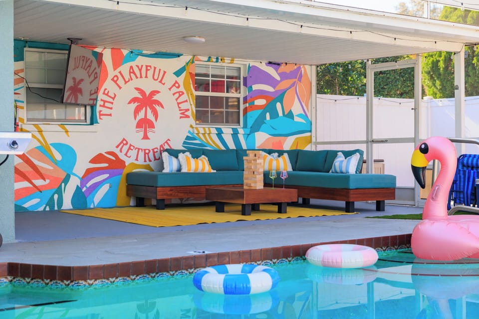 Shaded outdoor lounge with vibrant resort-style design and seating