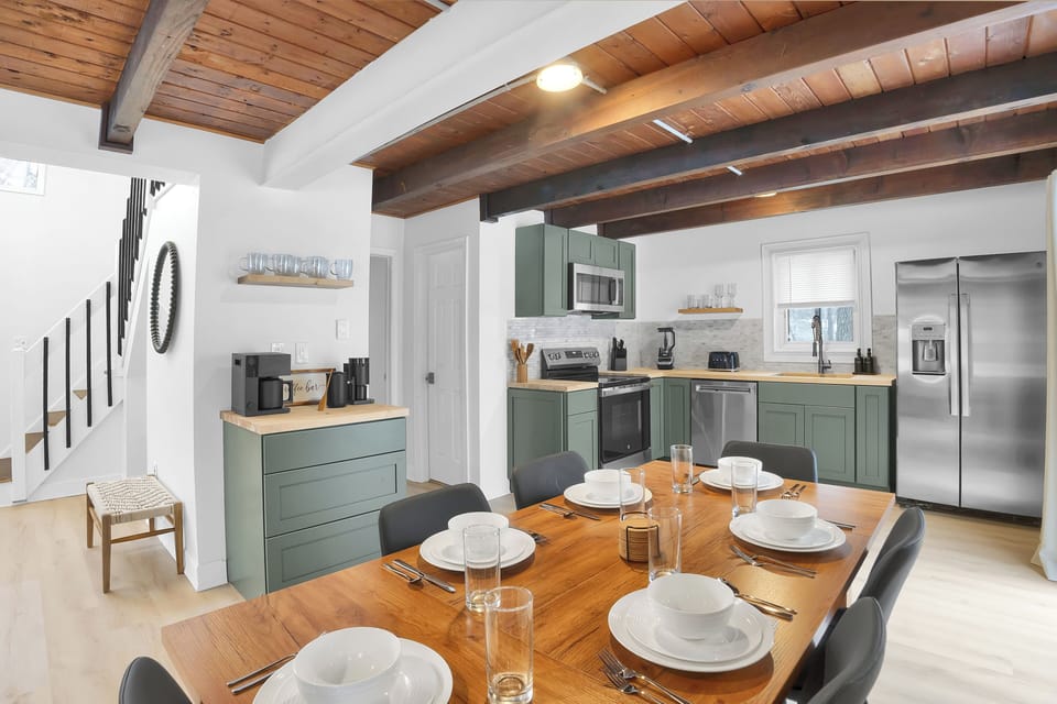 Gather around the dining table and enjoy a bright, open kitchen designed for easy meals and meaningful moments. With modern appliances, thoughtful touches, and warm wood accents overhead, it’s the perfect place to cook, connect, and linger together.