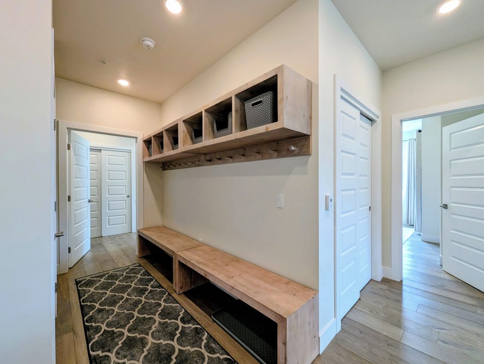 Kickoff your stay right in this welcoming mudroom, where custom wood cubbies and bench seating keep your gear organized and your vacation stress-free.