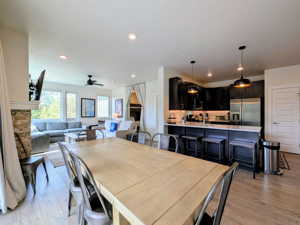 Gather around the spacious dining table or perch at the sleek kitchen island—this open-plan space invites you to cook, chat, and relax with natural light streaming in through large windows.