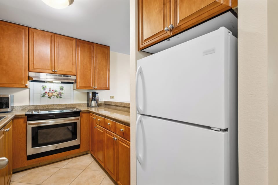 Step into your fully-equipped kitchen with warm wood cabinetry, modern appliances, and everything you need to whip up meals during your stay.