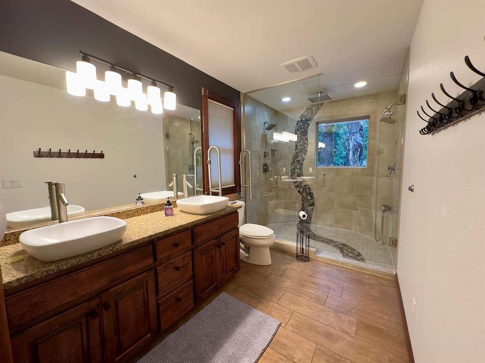 Spa-level shower with dual luxury shower heads plus a center rain shower — designed for total relaxation.