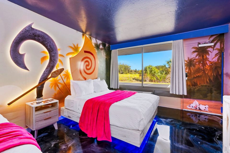 This tropical-themed room features vibrant wall art and a large window with natural views.
