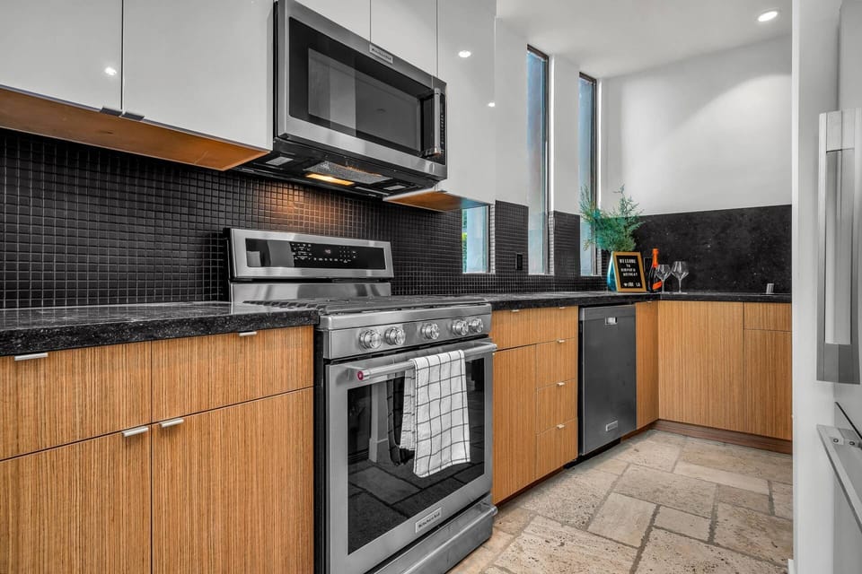 Modern full kitchen with warm wood accents.