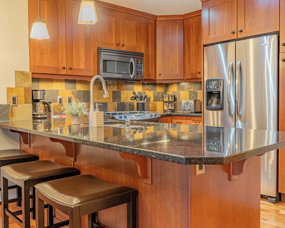 Fully stocked kitchen features stainless steel appliances
