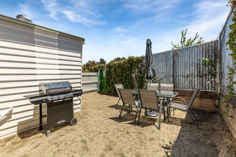 Rear courtyard with BBQ and outdoor furniture