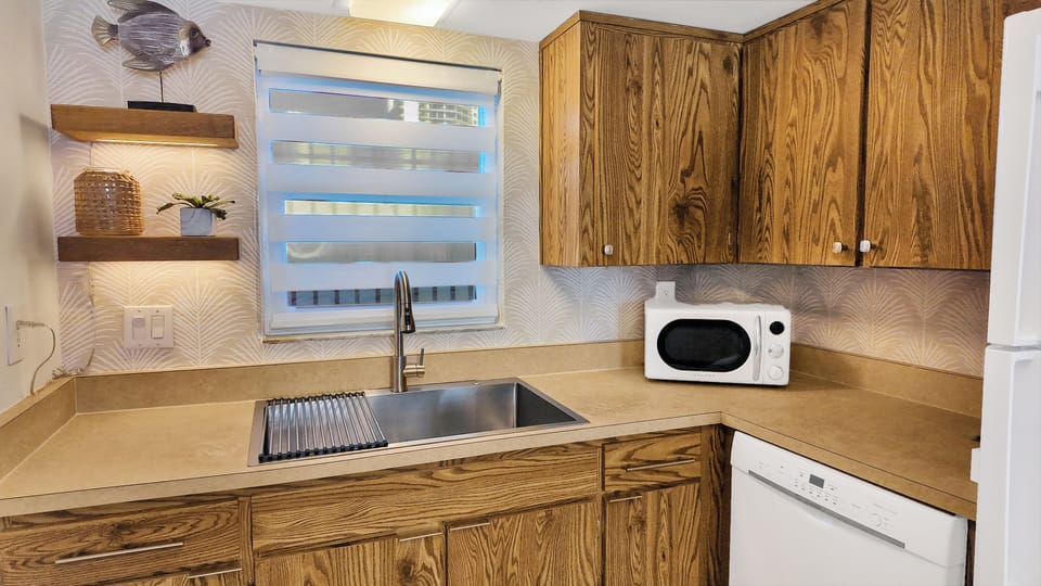 Oversize sink with garbage disposal, dishwasher, ice maker and refrigerator.