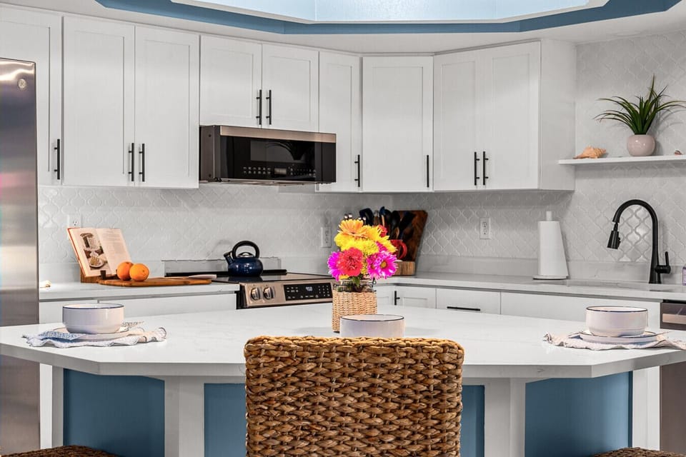 Bright, modern chef’s kitchen with spacious island seating — perfect for cooking together and gathering over morning coffee.