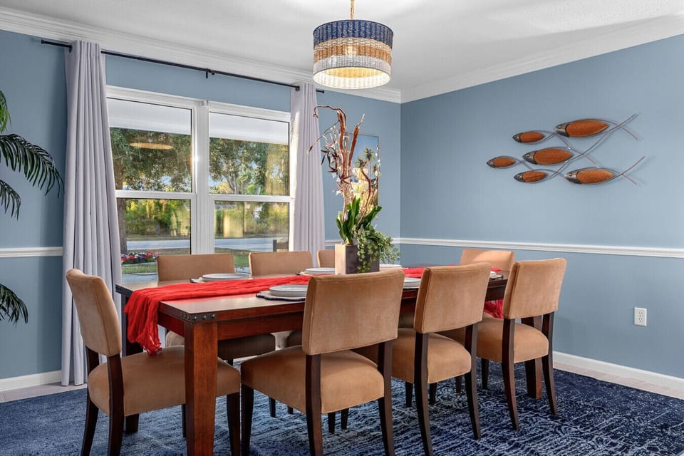 Elegant dining room for eight, featuring natural light, coastal décor, and the perfect setting for shared meals.