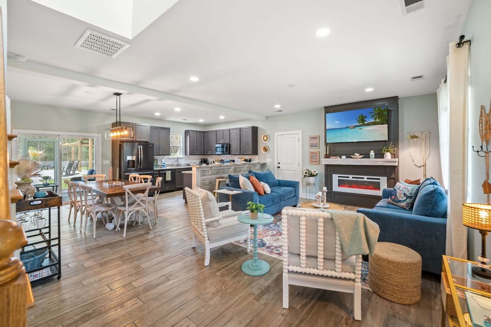 Open Floor Plan with the Living Room, Dining Table, Kitchen, Games, Laundry Room, a Pantry, a Half Bathroom, and the Screened-in Porch and Garage Access!