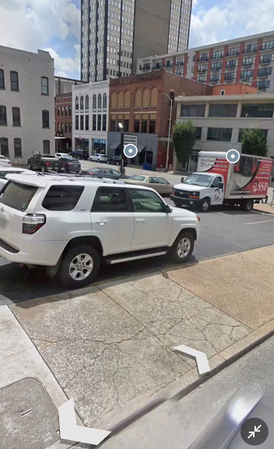 Parking lot located across the street from the buildings entrance.